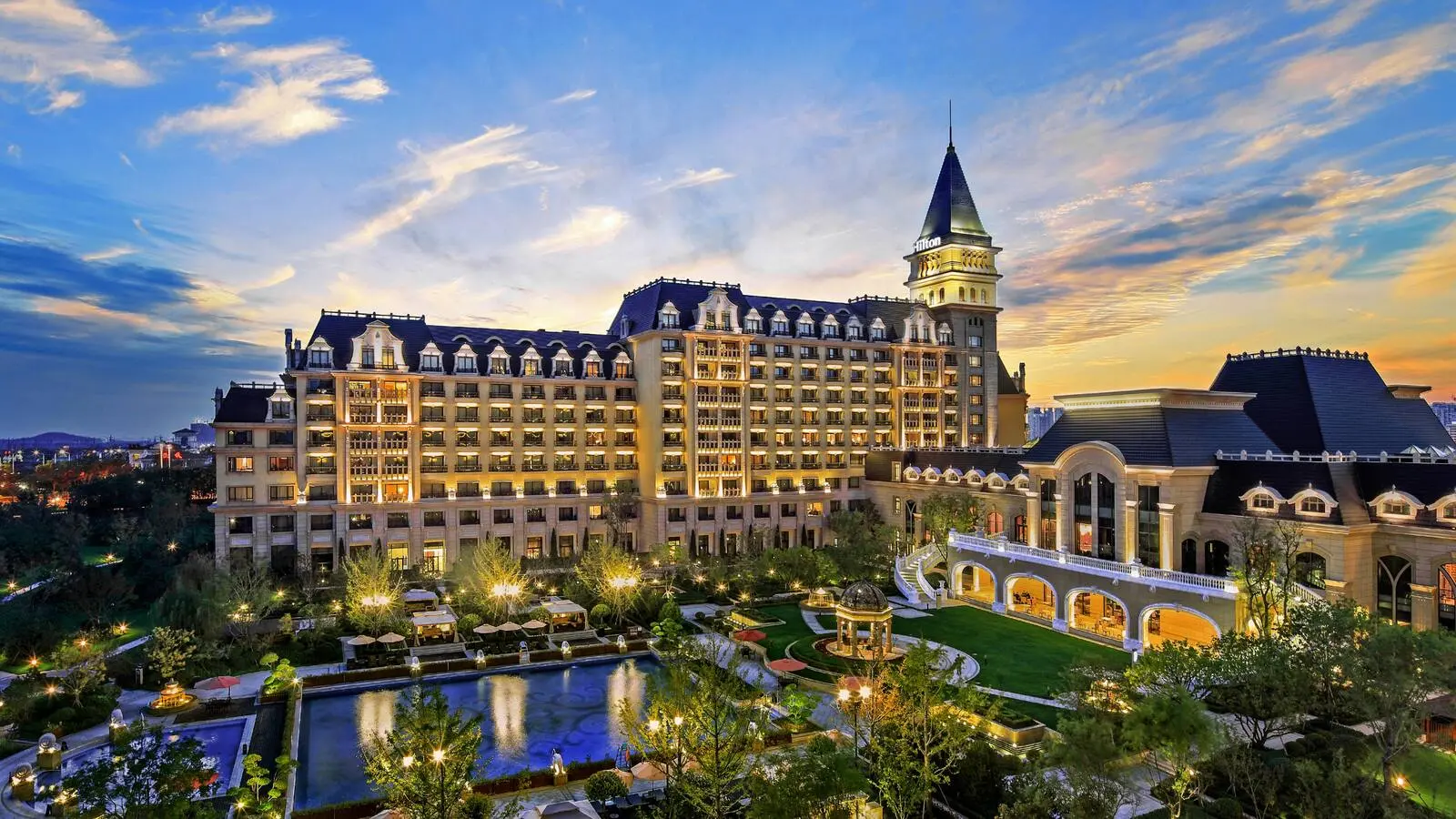 Exterior of Hilton Qingdao Golden Beach at dusk